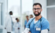 © peopleimages.com - Portrait, man and nurse with confidence at hospital for healthcare services, medical advice and trust. Smile, male person and arms crossed with about us, diagnosis and health insurance for treatment