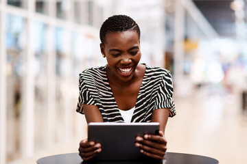 Canvas Print - Tablet, business and black woman laughing at funny story, creative gif or comedy script writer. Digital technology, online research and happy worker in startup for joke, reading meme and social media