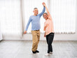 © artitwpd - Joyful senior couple dances together in bright room, embracing love, companionship, and active aging. They enjoy retirement, active, and aging gracefully. Sharing laughter, wellness, and togetherness.