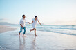 © peopleimages.com - Couple, running and holding hands on vacation, beach and outdoor with adventure, love and bonding in summer. People, man and woman with connection, care and happy on holiday by ocean in Indonesia