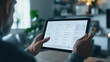 © CreativeIMGIdeas - Focused on Tasks: A man's hands navigate a tablet, meticulously reviewing a list of tasks. This image captures the focused nature of work.