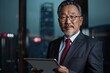 © Rezeda - A man in a suit and tie is holding a tablet in his hand