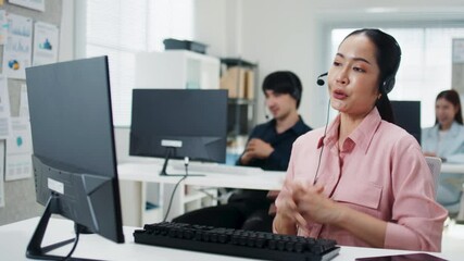 Wall Mural - Asian woman call center agent, customer service, tech support with headphones working on computer for online consultant, assistance, customer support in call center office. Telemarketing and Business