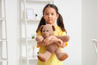 © Pixel-Shot - Little Asian girl with autistic disorder and toy bear at home