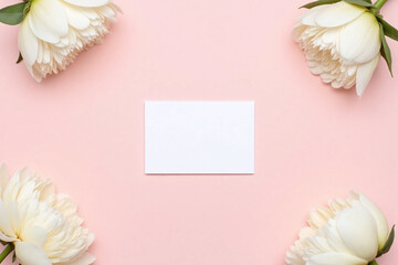 Wall Mural - Small white card surrounded by white peonies on soft pink background