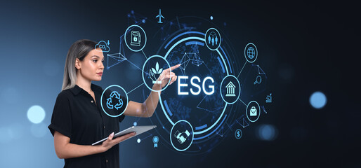 Woman interacting with ESG concept icons on digital interface.