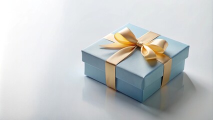 Poster - A light blue gift box with a golden ribbon bow sits on a white surface, reflecting the light in a subtle and elegant manner.