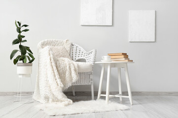 Wall Mural - Interior of living room with white armchair, table and paintings