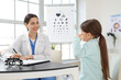 © Pixel-Shot - Female ophthalmologist working with little girl at table in clinic