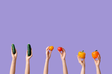 Wall Mural - Female hands holding fresh vegetables on lilac background