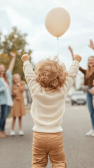 joyful caucasian child celebrating outdoors with family and friends