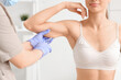 © Pixel-Shot - Young woman receiving injection in her arm at cosmetologist's office, closeup