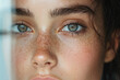 © annmelnikova - Close-up of young caucasian female with freckles and blue-green eyes