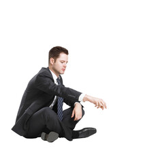 Poster - Businessman sitting cross-legged, wearing a formal suit and reaching out with one hand, isolated on a white background. Concept of corporate focus