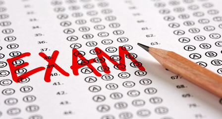 Wall Mural - Close up view of a test exam paper with the word exam and a pencil.
