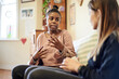 © MikoN/peopleimages.com - Counseling, child and psychologist woman talking, support and help with problem, mental health or therapy consultation. Listening, empathy and therapist person, african kid and school or life advice
