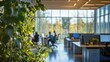 © Rifqi - Modern office workspace, blurred business people working at desks near large windows, green plants in foreground; ideal for concepts related to business, corporate, teamwork, and office design