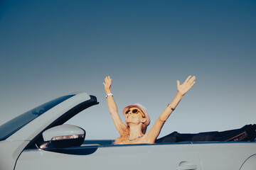 Wall Mural - Happy young woman travel by car by the sea