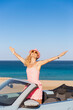 © Sunny studio - Happy young woman travel by car by the sea