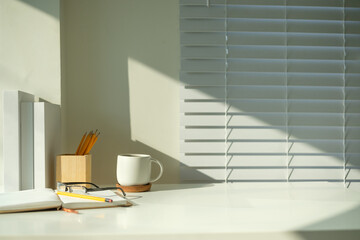 Wall Mural - Workspace includes an open notebook with glasses and a pencil, coffee mug, and pencil holder.