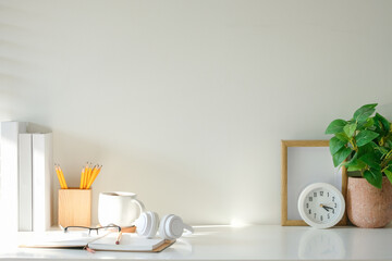 Wall Mural - Creative workplace with an open notebook, glasses, a coffee mug, and headphones.