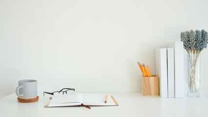 Wall Mural - Workspace with open notebook with a pencil, glasses and coffee mug on a cork coaster.