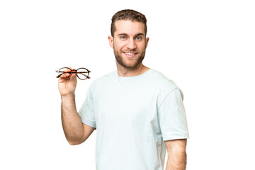 Wall Mural - Young handsome blonde man with glasses over isolated chroma key background smiling a lot