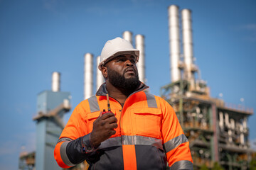 Sticker - Engineers wearing safety gear, including hard hats examining survey standing industrial facility gas or oil refinery engaged in a job requires high safety standards concept.	