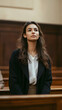 © charli - A courtroom scene where a confident woman stands before a wooden bench and an unseen audience, suggesting a pivotal moment  -