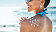 © Donson2000/peopleimages.com - Woman, sunscreen and shoulder on beach, skincare protection and outdoor travel to ocean. Female person, carefree summer and spf lotion for cosmetics by waves, nature and relax on holiday in Bali