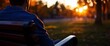 © DYAH - Contemplating the Sunset A Lone Figure on a Bench Immersed in Golden Hour