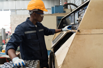 Fototapete - Professional African American male engineer working with cnc machine in the industry factory. Male engineer control cnc machine in manufacturing industry factory