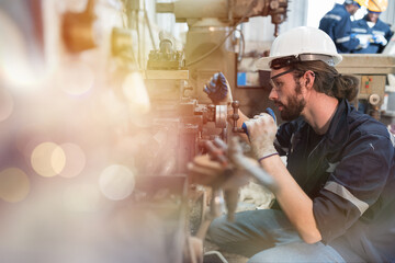 Poster - Professional male engineer maintenance lathe machine in industry factory. Engineer repairing lathe machine with safety uniform, goggles and helmet