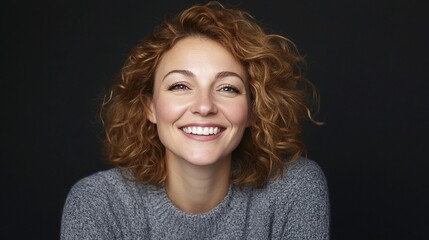 Wall Mural - Happy woman smiling, studio portrait, dark background, website use