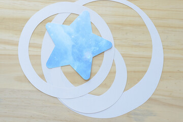 Wall Mural - machine-cut blue paper star and concentric rings on wood