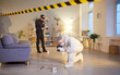 © Studio Romantic - Photographing evidence, crime scene photography, investigator, policeman and professional criminological expert white coverall inspecting, examining behind barricade tape, yellow police line, safety