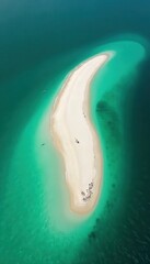 Wall Mural - emerald green water surrounds a crescent-shaped sandbar , pristine, ocean