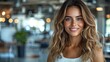 © Рудой Максим - Smiling woman with long wavy hair in a modern cafe setting with soft lighting and an inviting atmosphere