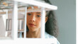 © Summit Art Creations - Closeup image of young hispanic architect engineer inspect house model construction. Project manager looking inside building while checking architectural model structure. Focus on face. Manipulator.