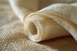 © kaleidoscope - Bamboo fiber fabric is coiled, showcasing its soft texture and eco-friendly qualities in natural light