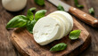 © Oleksiy - mozzarella with basil on wooden board. selective focus