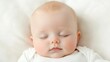 © BROPRADANA - Peaceful baby sleeping soundly on white bedding