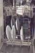 © Natalia - Cutlery, plates, cups in the dishwasher. Household.