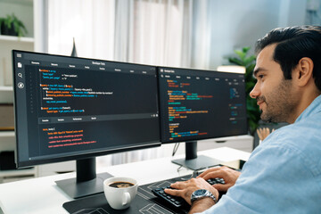 concentrating in smart it developer working software development coding on two pc screen, creating v