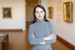 © JackF - Interested woman tourist visiting exhibition of antique paintings in art museum..