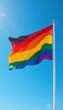 © Pawarit - Flag's vibrant colors against a bright blue sky, sun, waving flag, serene scene