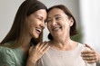 © fizkes - Close up portrait two beautiful different generation women, daughter and mother smiling warmly looking at each other with love and tenderness, hugging indoor. Happy family, ties, bond, understanding