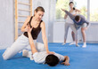 © JackF - Young woman and young man practicing self-defense techniques in gym..