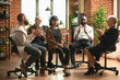 © DC Studio - Supportive community clapping for young woman during aa meeting in brick wall office. Caucasian lady sitting in middle of circle being celebrated for mental health recovery at group therapy session.