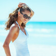 © Alliance - young woman in eyeglasses on beach